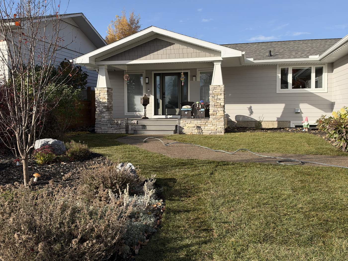 The same front yard finished in new sod, the house and porch behind