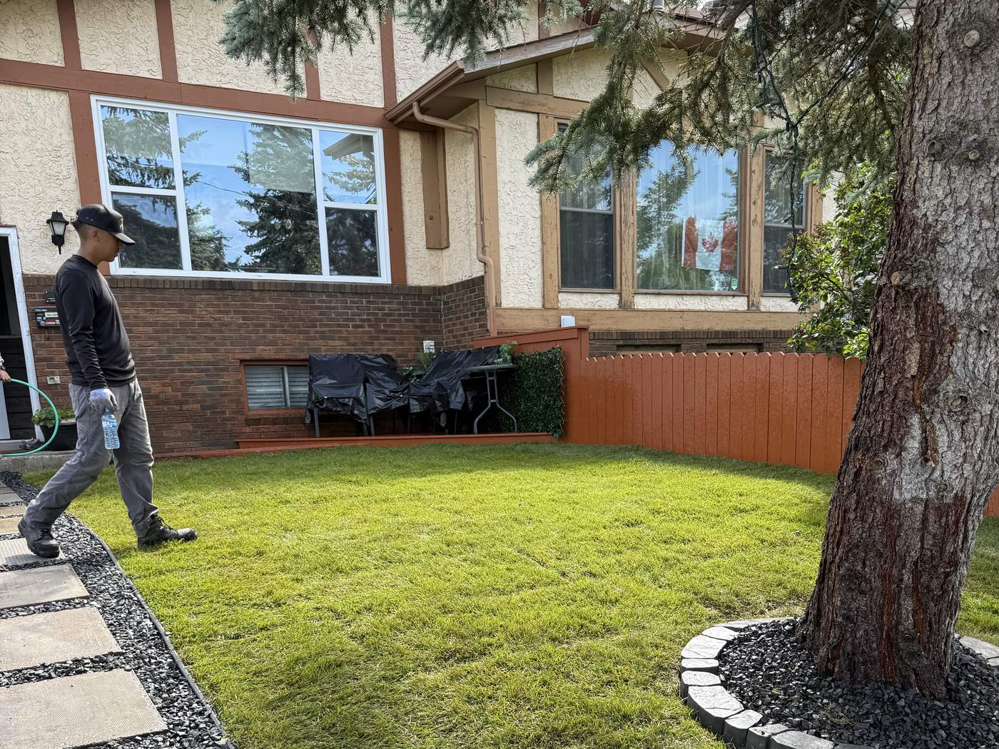 Local Lawns crew member walking a finished, freshly sodded back yard in Calgary
