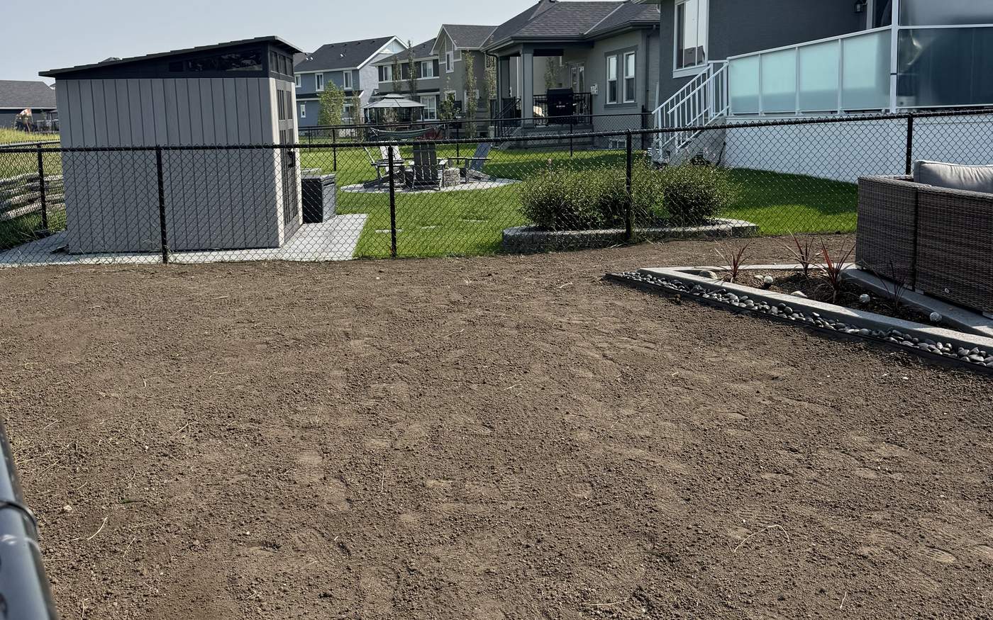 Calgary back yard with the old sod stripped and the grade re-cut before fresh sod goes down