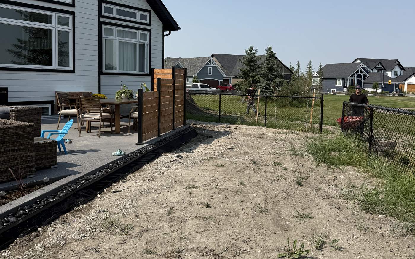 Chestermere back yard with the old lawn stripped and the grade re-cut before fresh sod goes down
